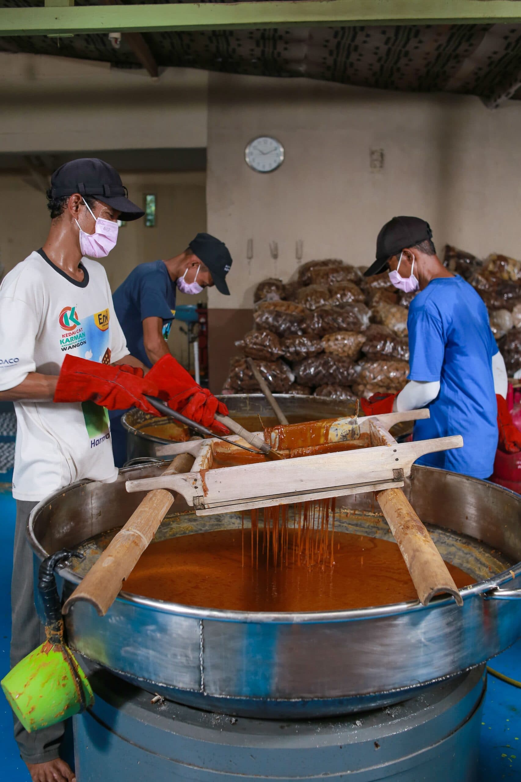 Workers boiling coconut sap for sugar