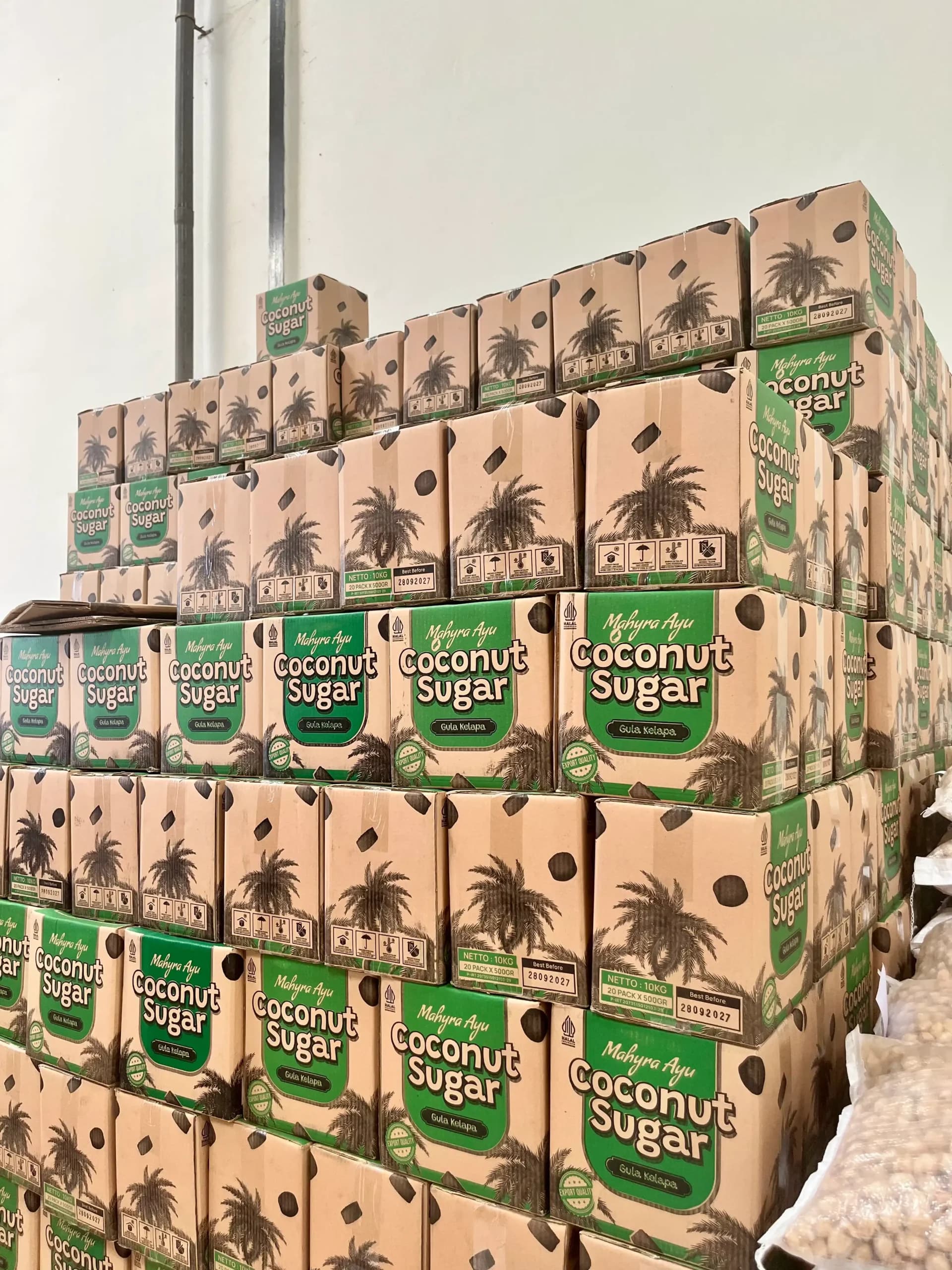 stacked export boxes of coconut sugar